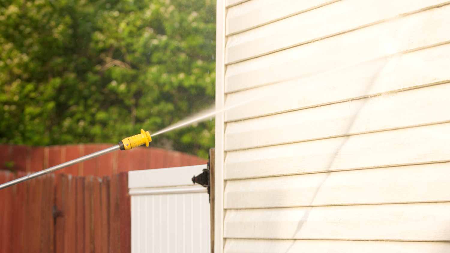 Cleaning house with pressure washing machine