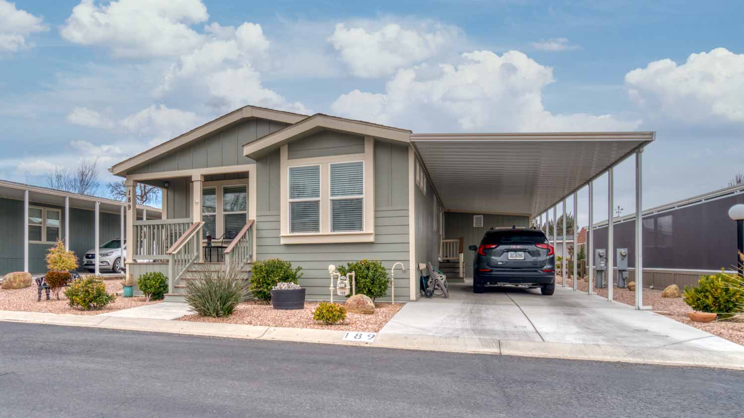 A mobile home with a covered parking area