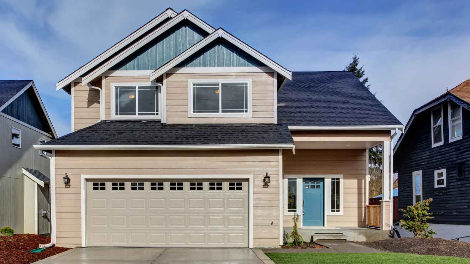 beige home with blue roof and door