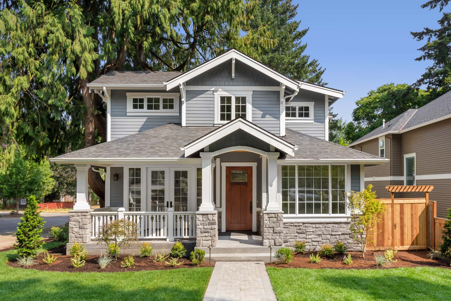 House exterior with covered porch and green grass