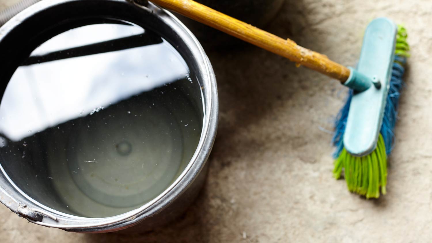 floor bristle brush and bucket of water