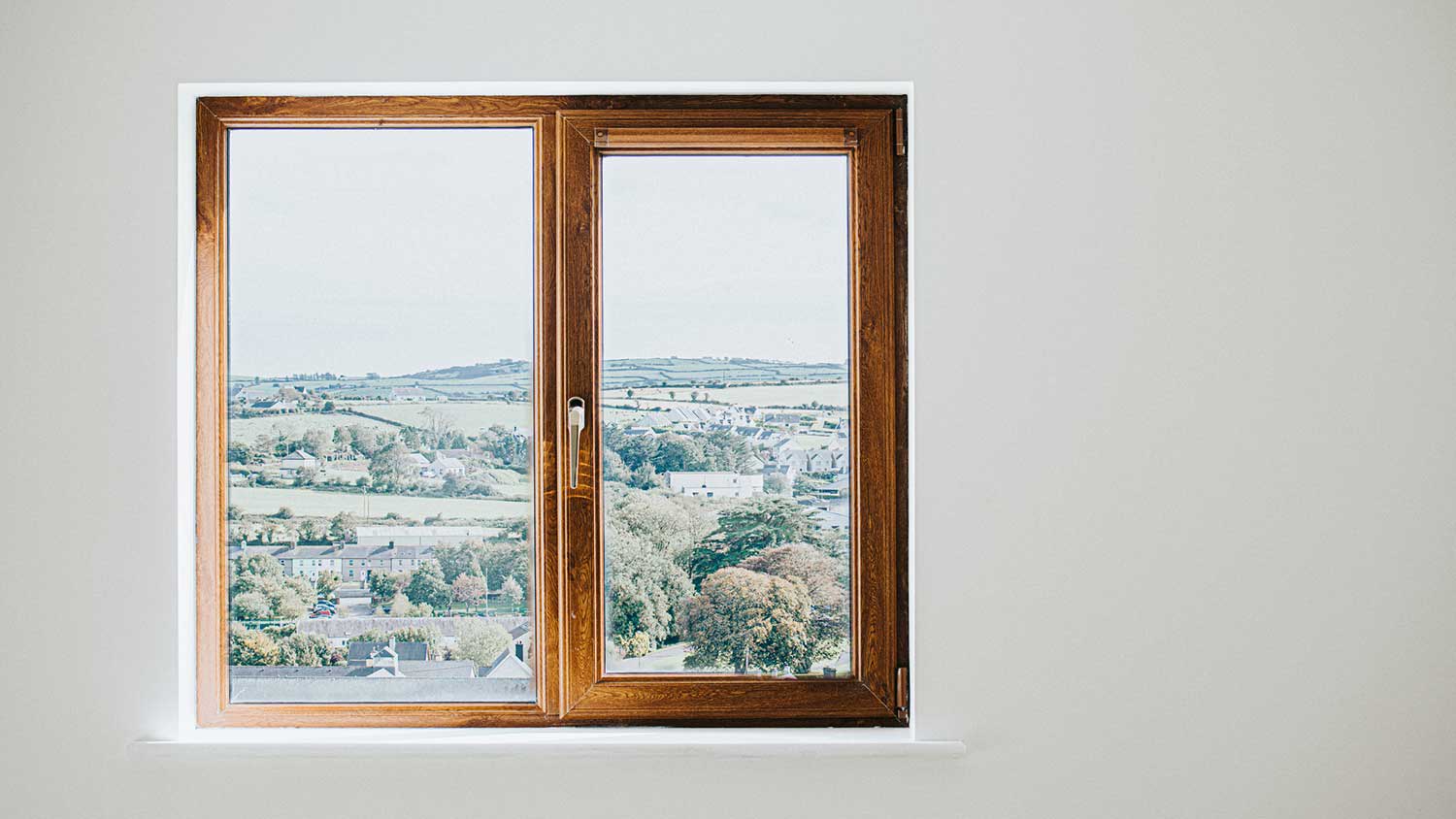 Wooden casement window in a white wall