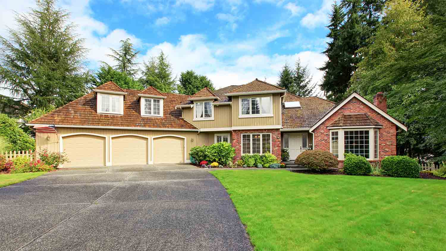 large luxury brick house with driveway