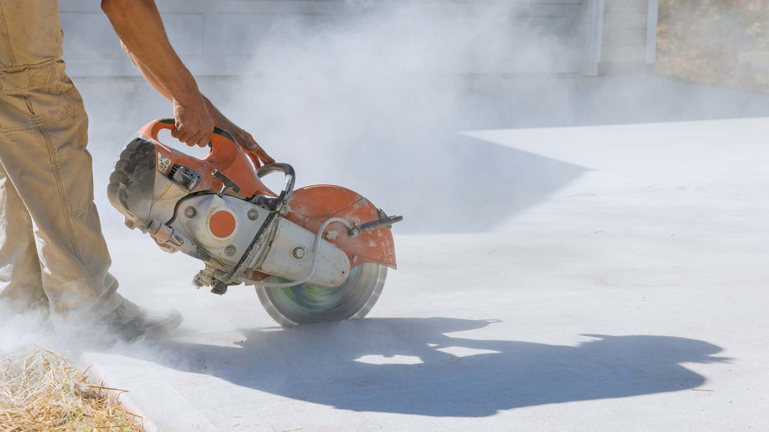A man cutting a concrete slab