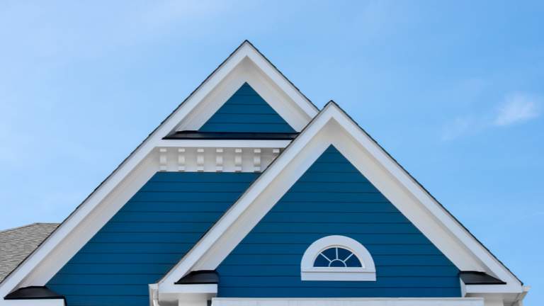 House with vinyl siding painted blue