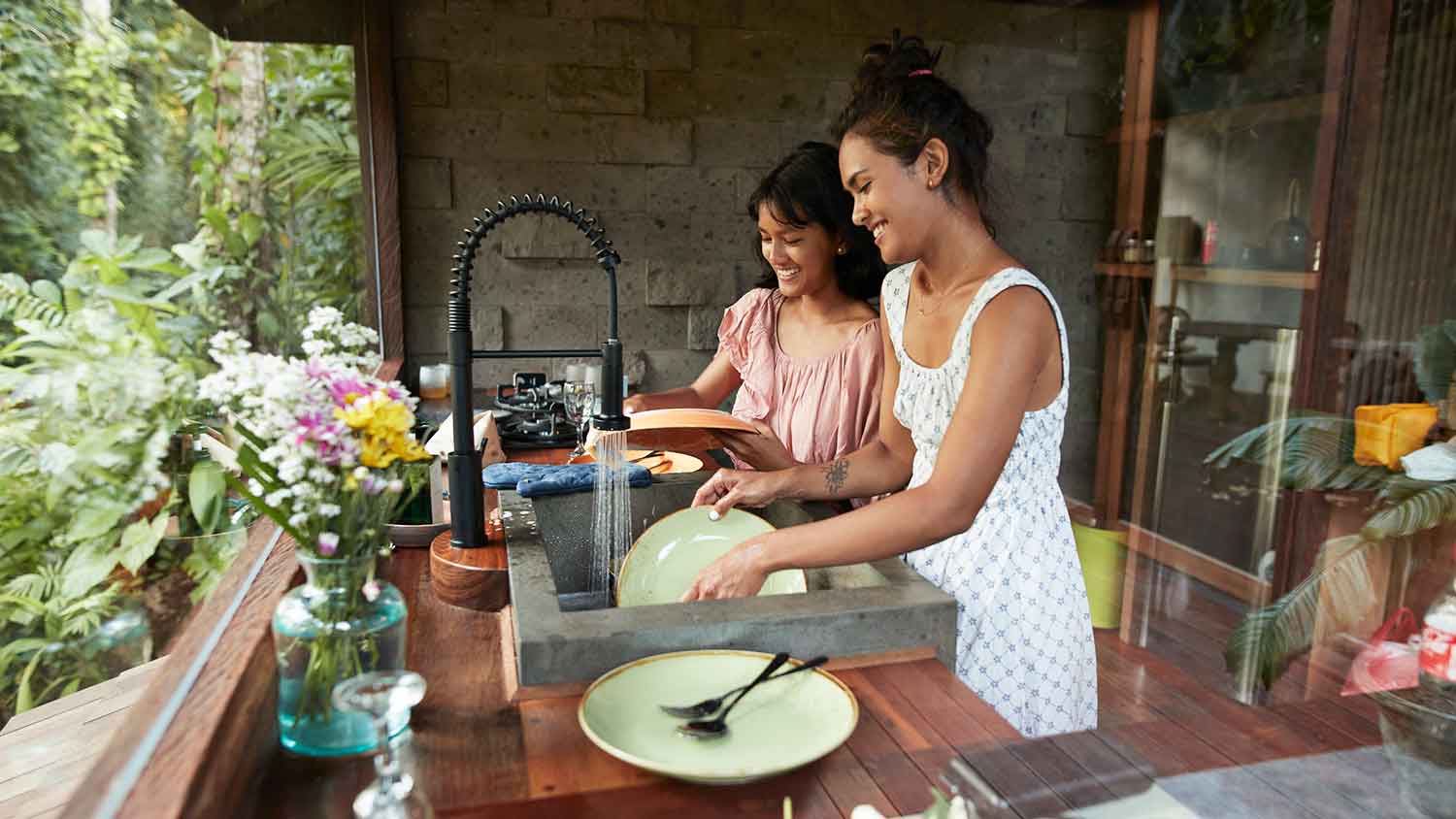Sisters washing dishes together