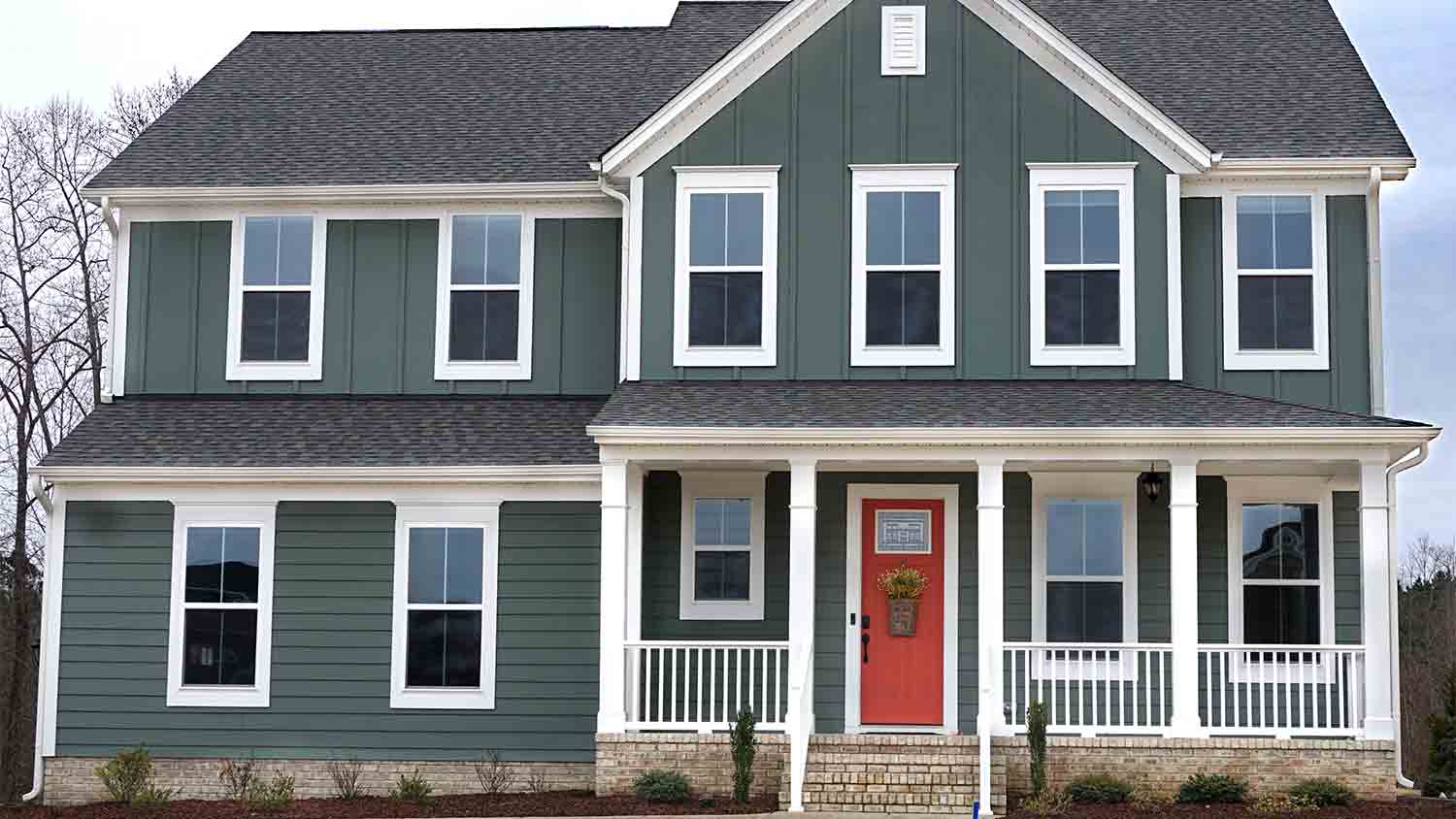 house with forest green vinyl siding