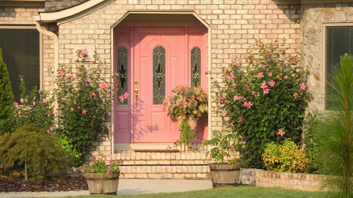 A large house with a pink front door