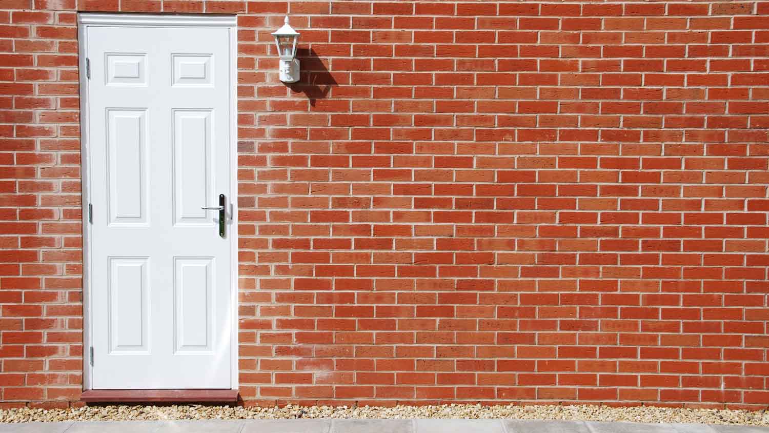 A red brick house with a white door