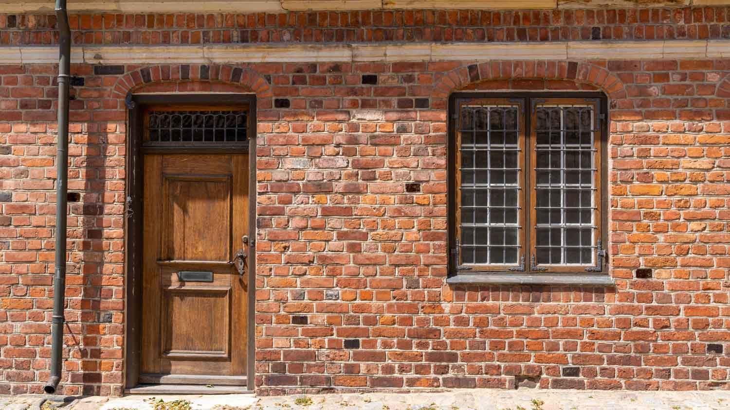 A brick house with a wood stained door