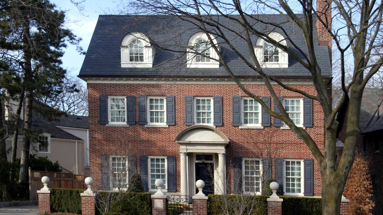 Brick house with dormers and shutters