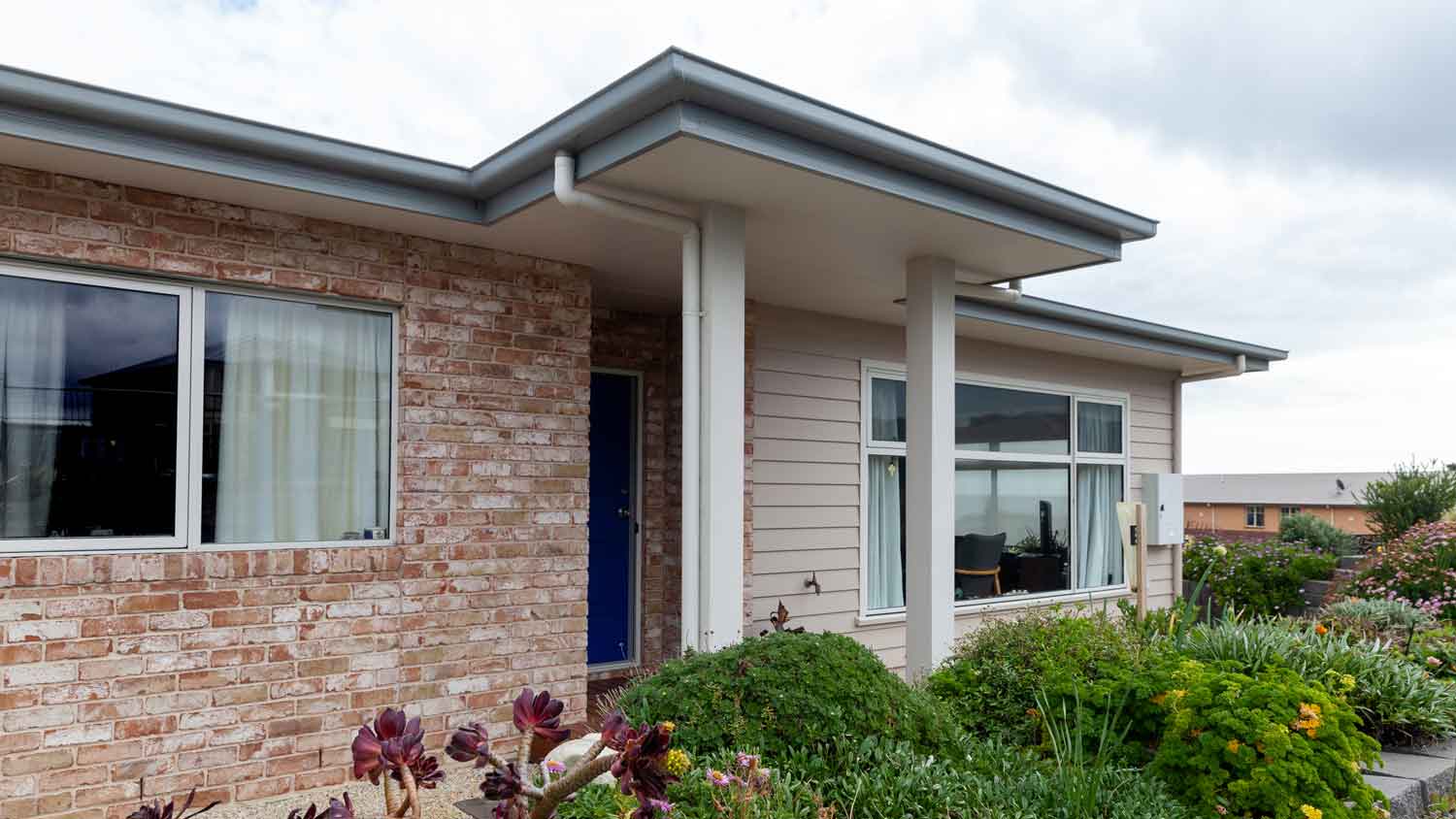 A house with a mix of brick veneer and vinyl siding