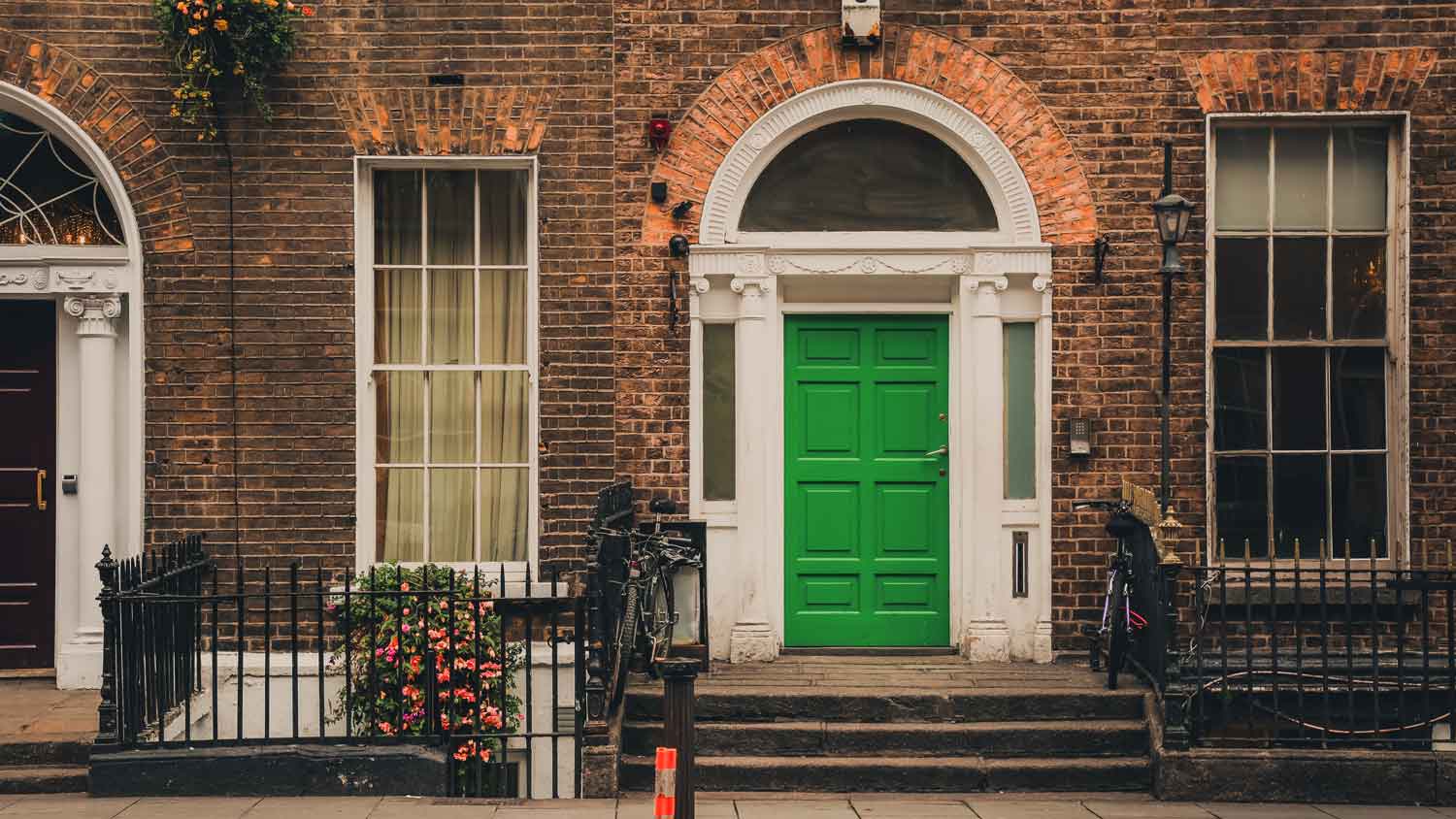 A red brick house with a green door
