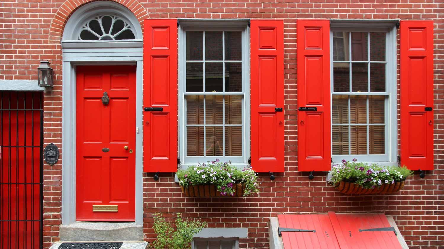 Brick house with red shutters