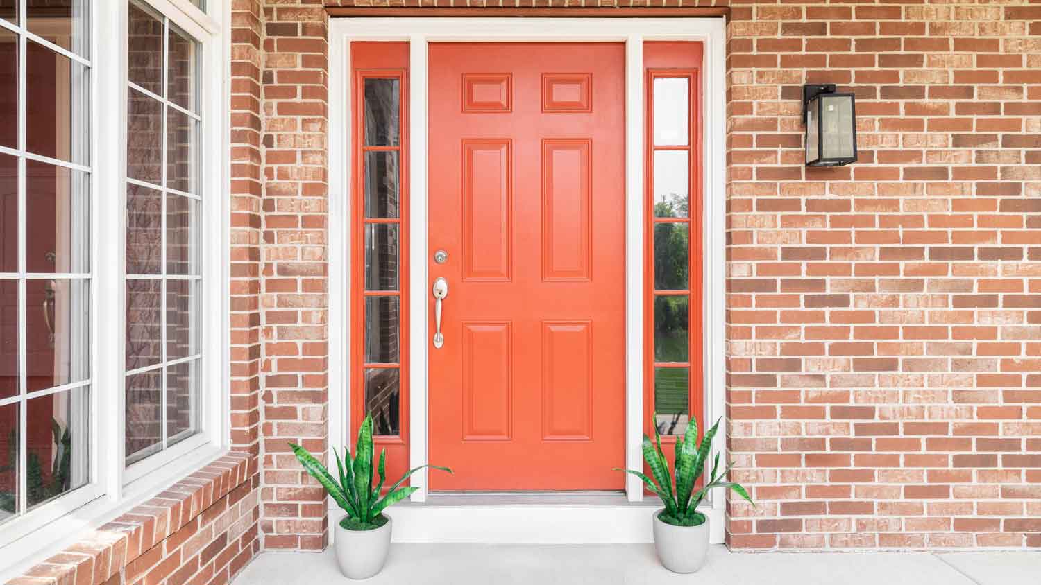 A red brick house with an orange door