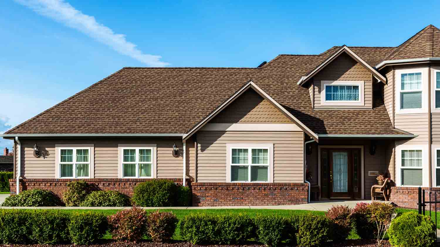 large beige home with beige roof
