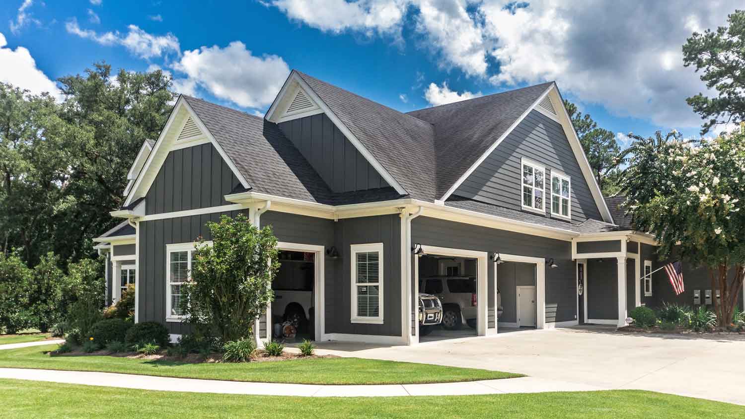 Large gray house with concrete driveway