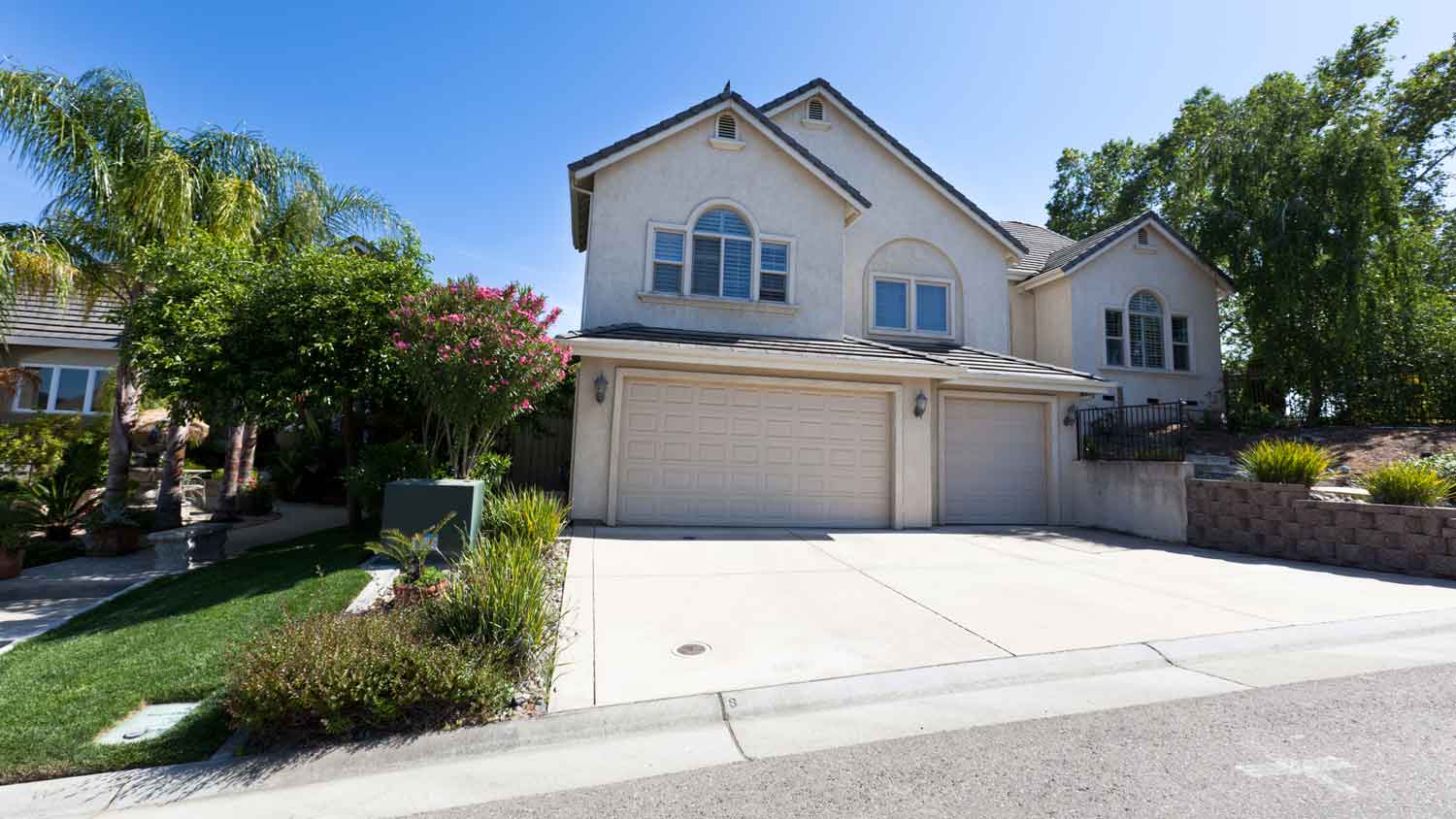 A suburban house with a concrete driveway