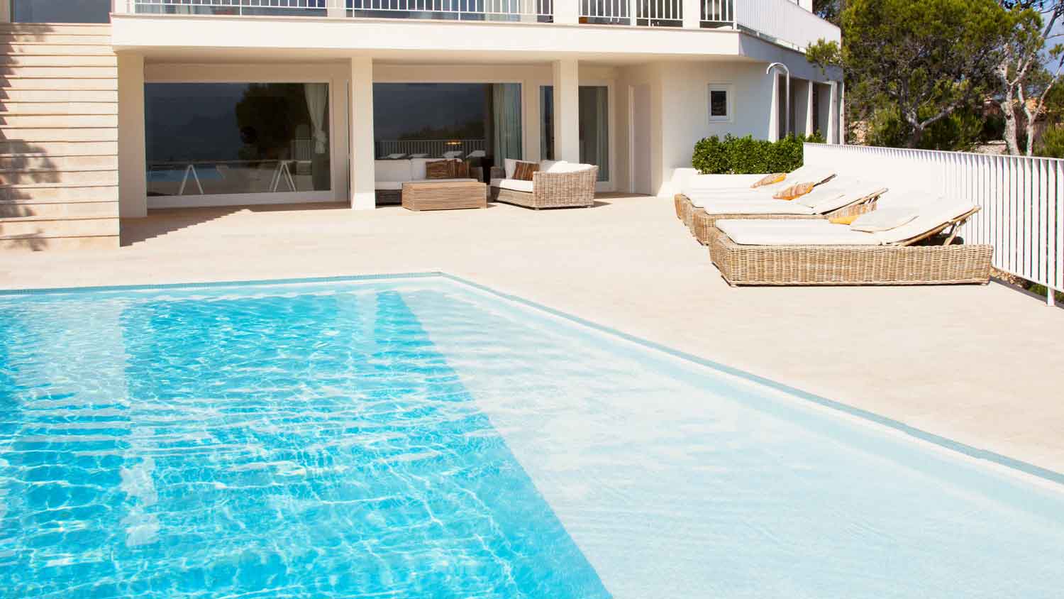 large home with white swimming pool deck
