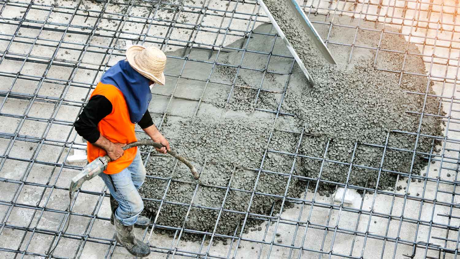 Top view of a builder pouring concrete on a construction site