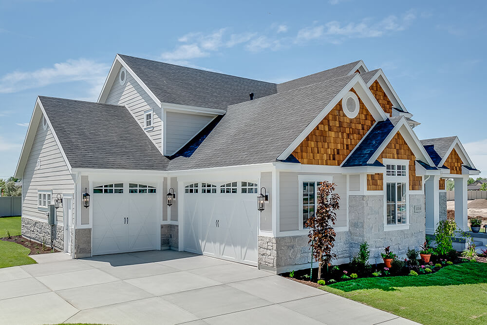 Garage view of home with shingle roof