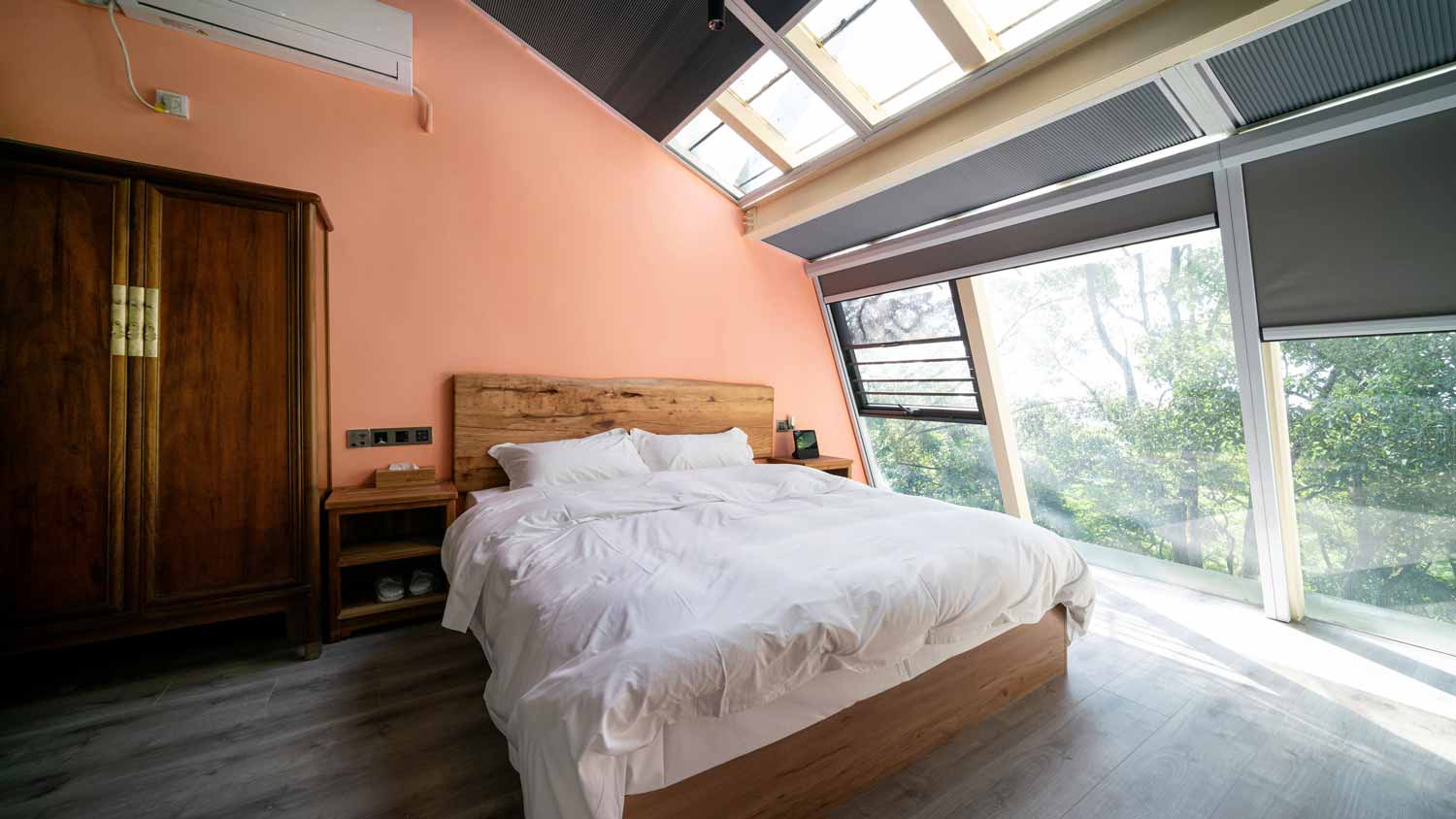 A bright bedroom with a wooden closet