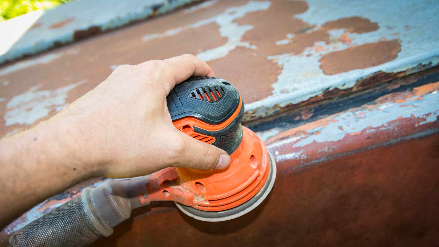 man operating disc sander on furniture