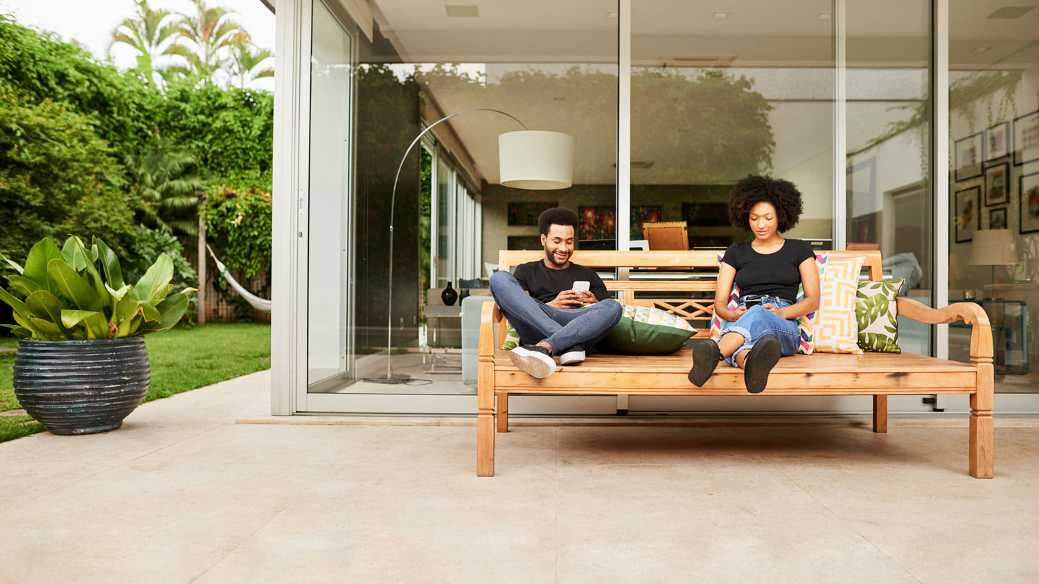 Couple sitting on patio outside modern house