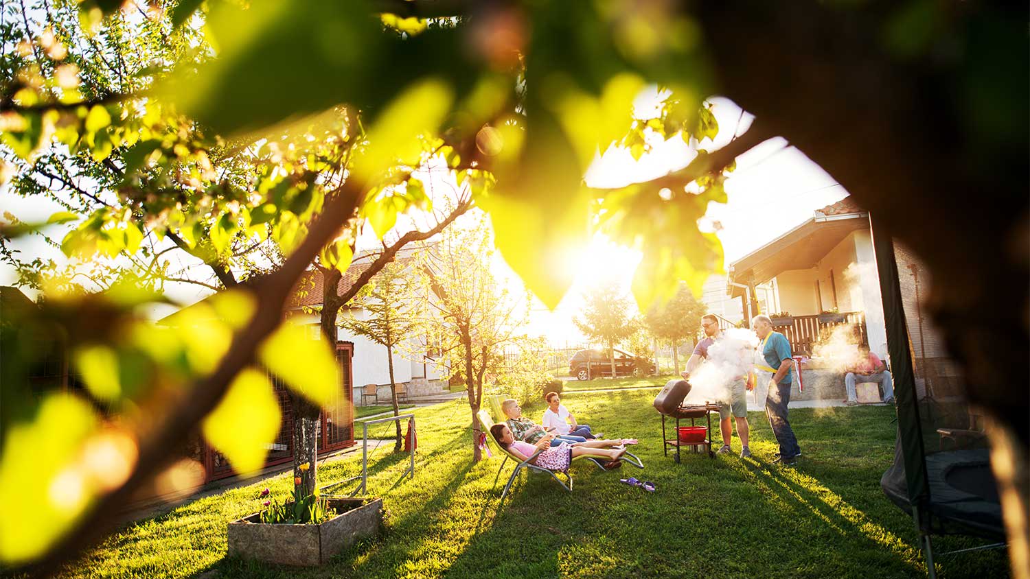 A family barbecues in the backyard