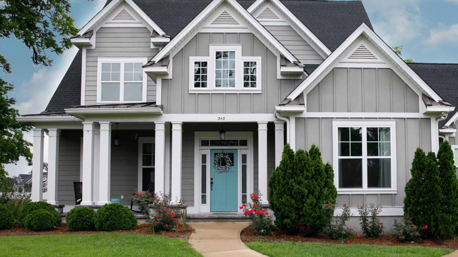 Gray house with light blue front door, including different tones of light blue paint