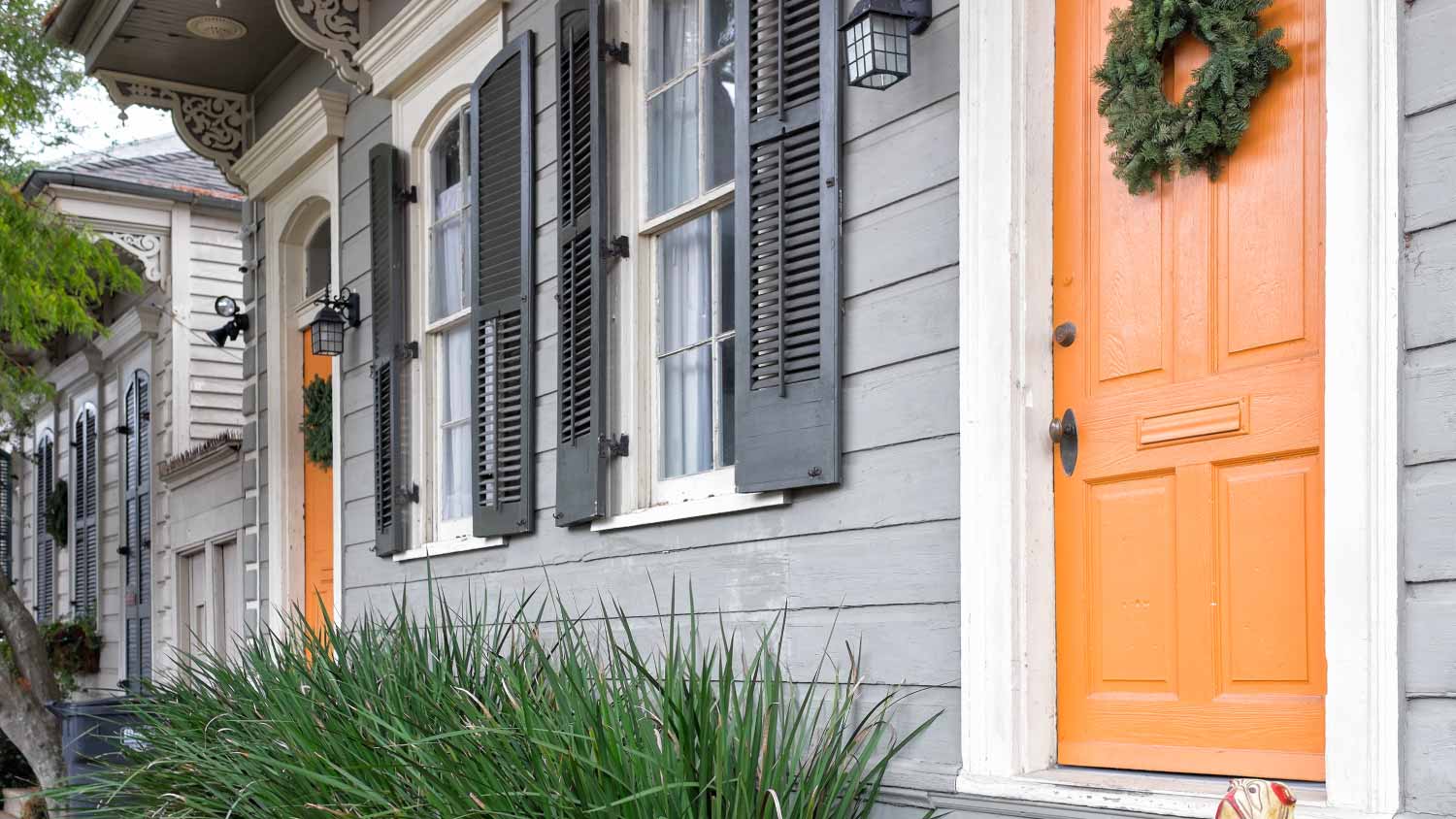 Gray house with orange front door, including different tones of orange paint