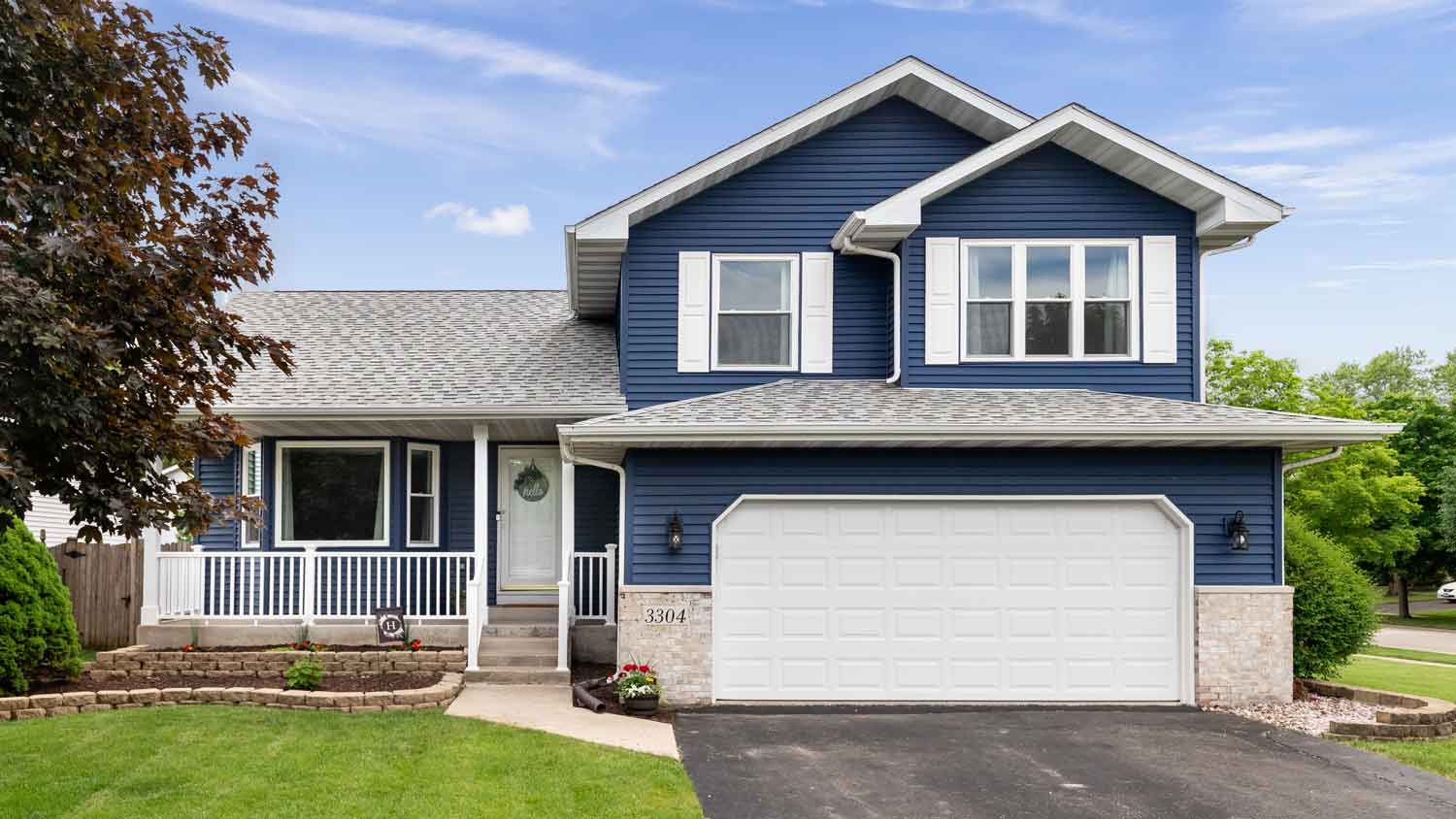 dark blue home with white porch