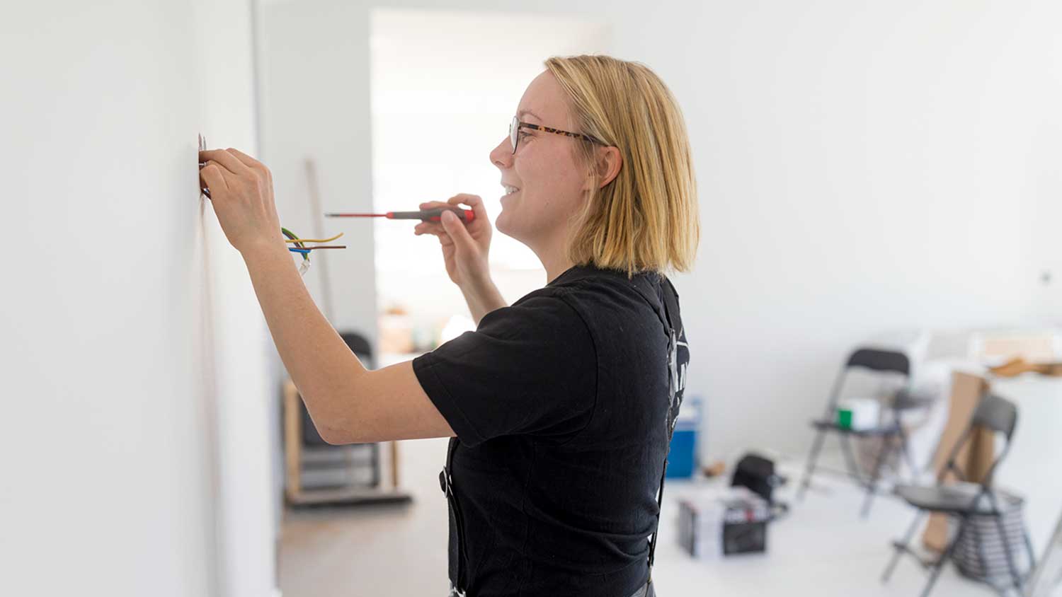 Female electrician wiring new house
