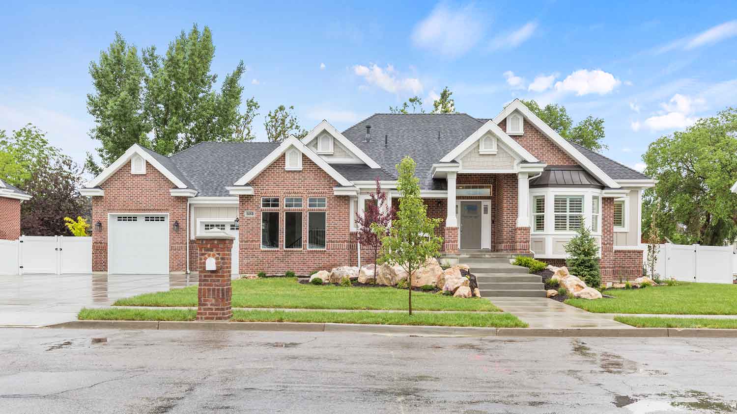 Large brick house on a wet street