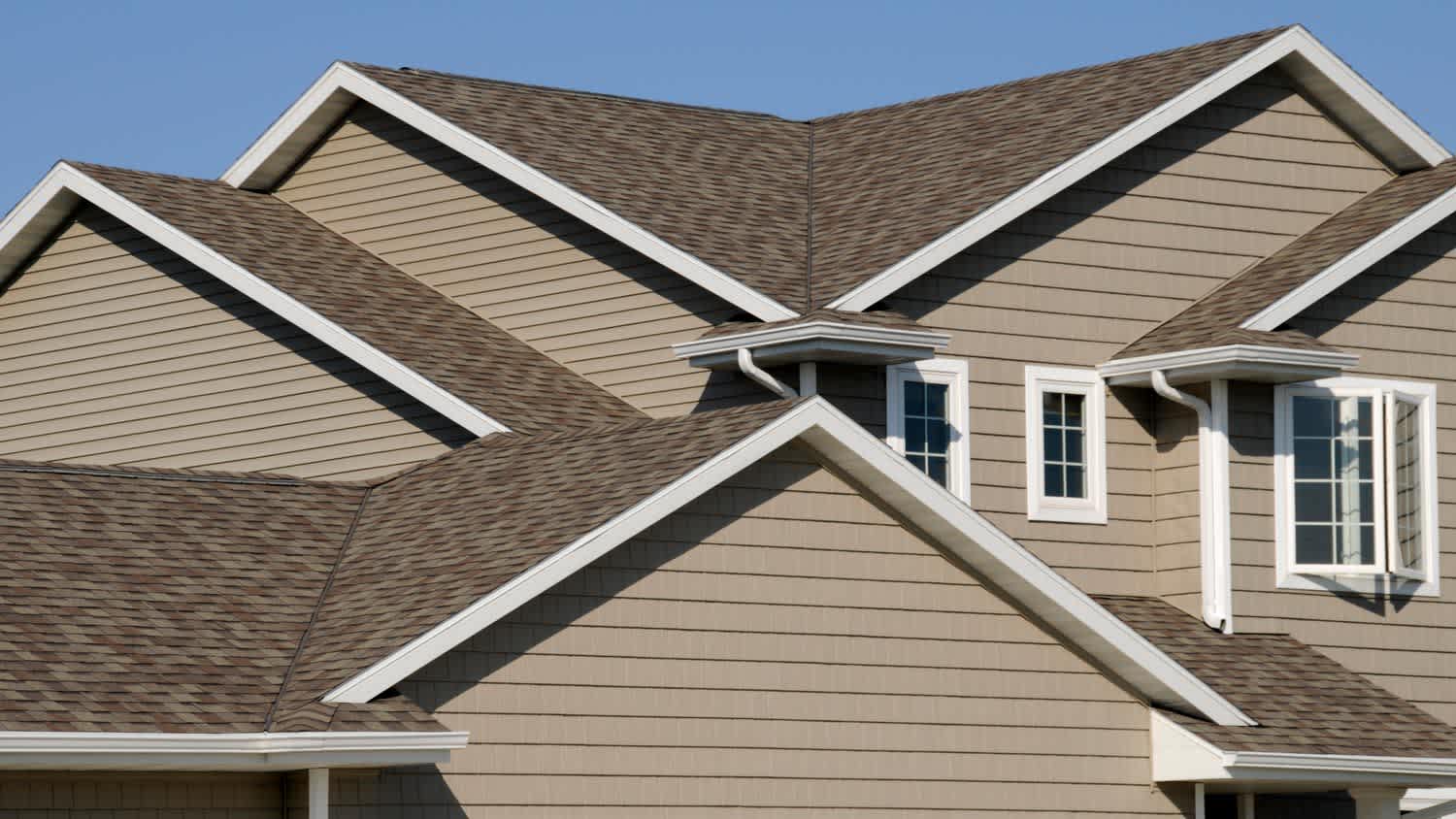 A closeup of a rooftop against a bright blue sky
