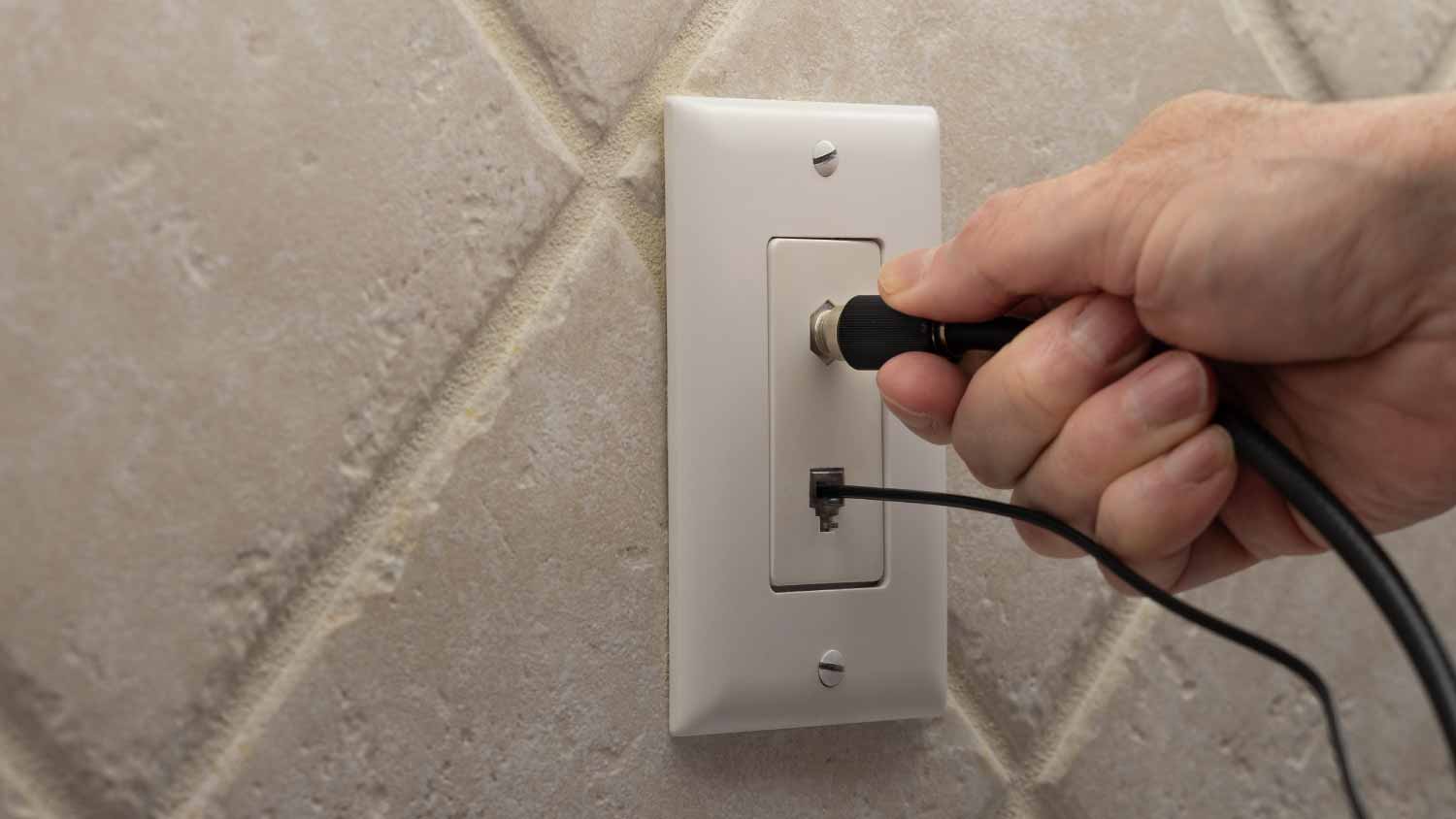 Electrician connecting coax cable