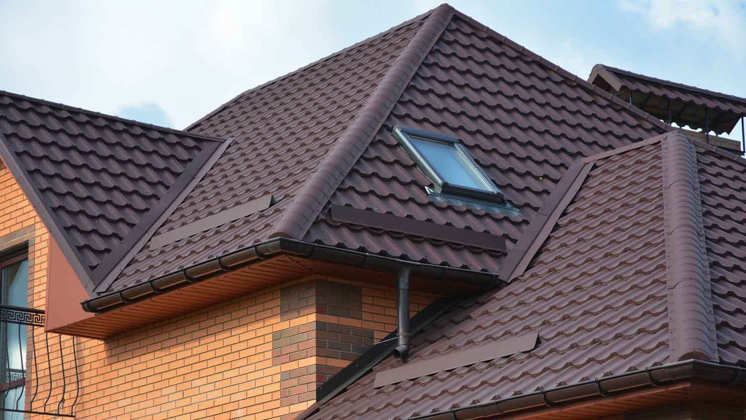 A brick house with a metal roof