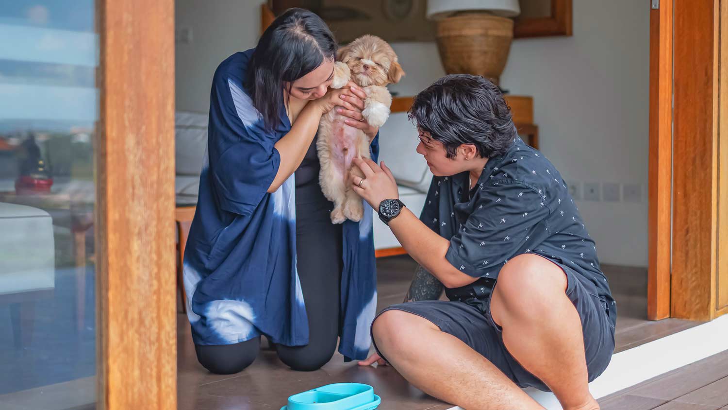 couple inspecting puppy for fleas