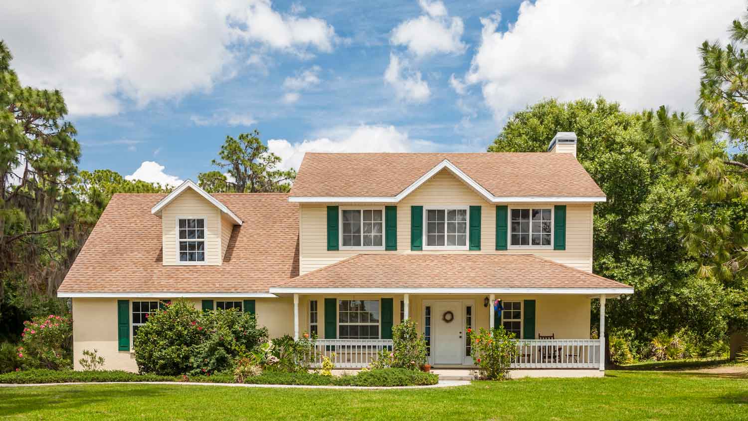 A traditional house in a rural setting with green shutters