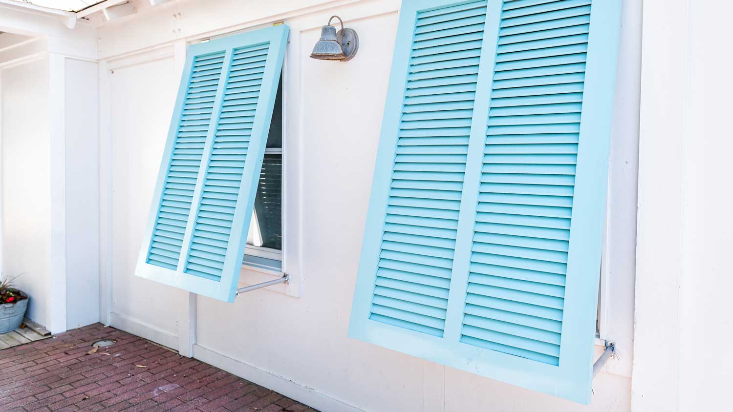 Turquoise blue shutters on a white house