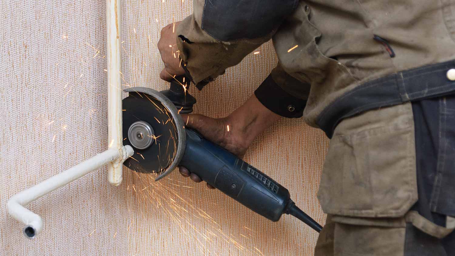 Plumber cutting the metal pipe