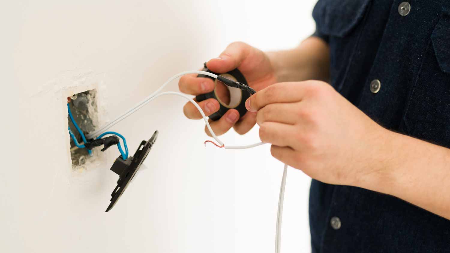 Handyman putting tape on broken cables
