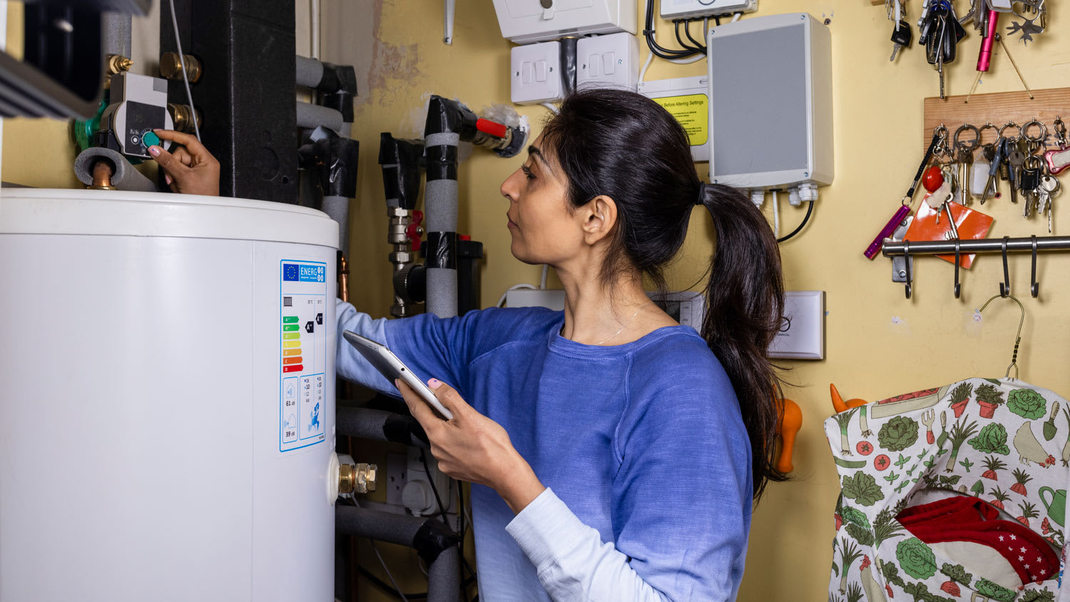 Woman turning down her thermostat