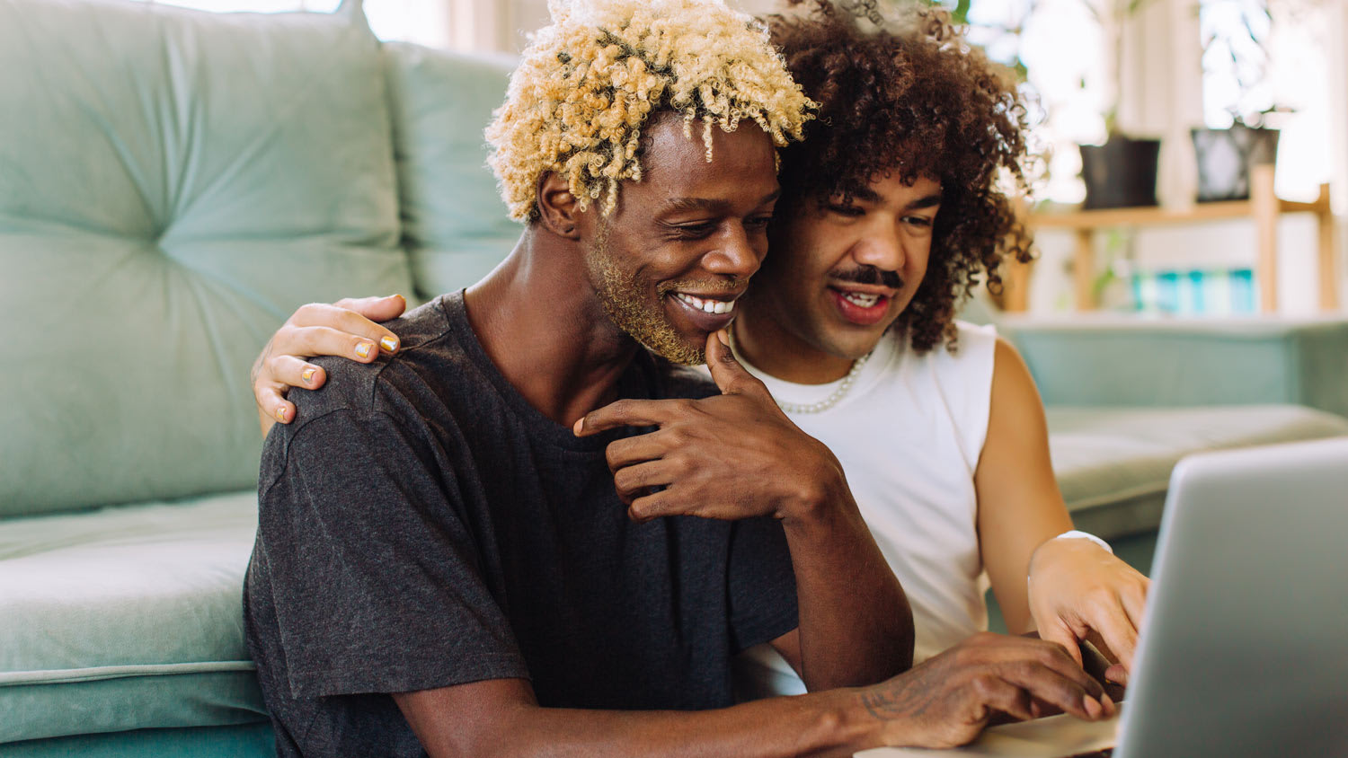 A couple using a laptop in their living room