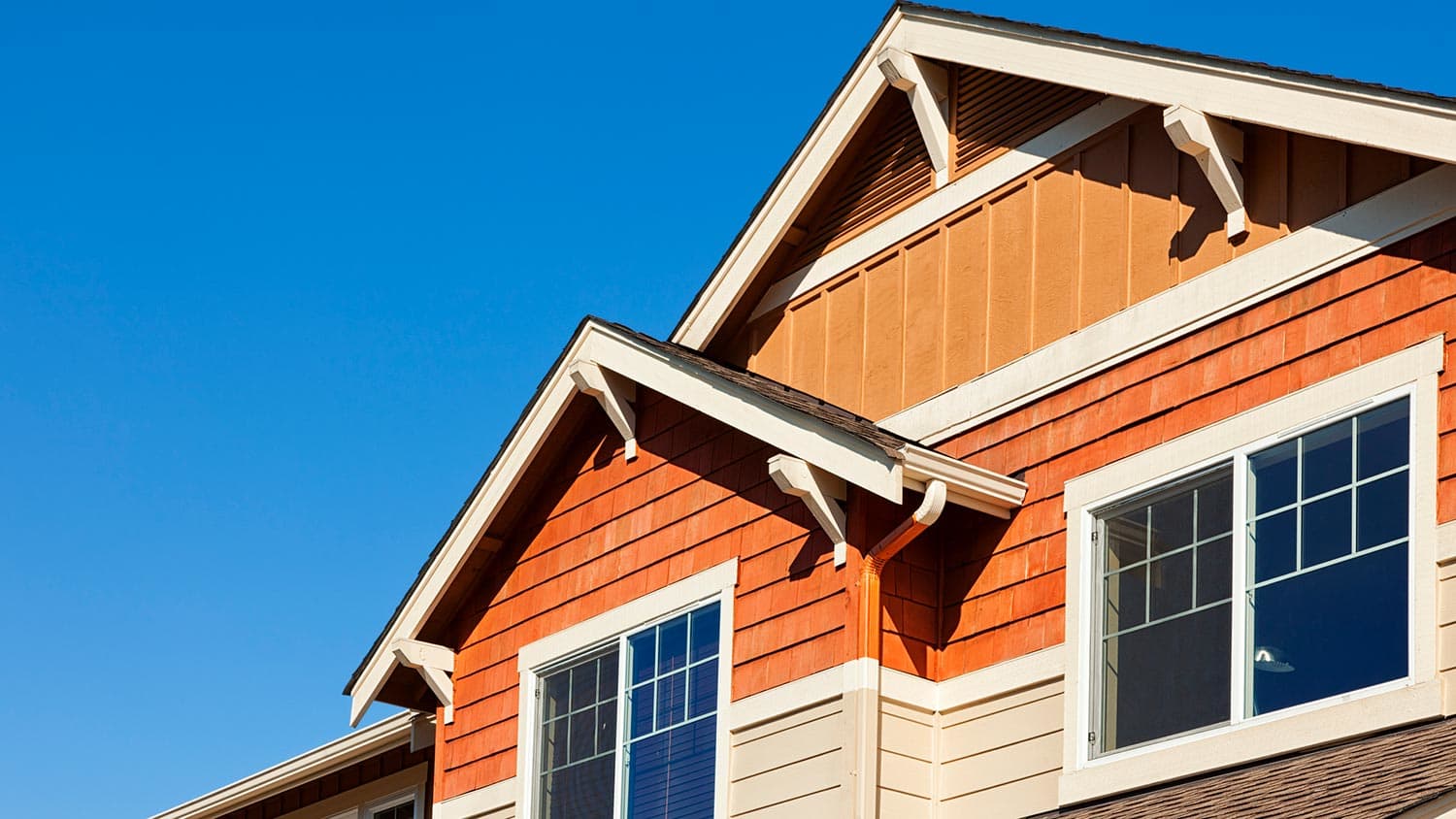 House rooftop against clear blue sky