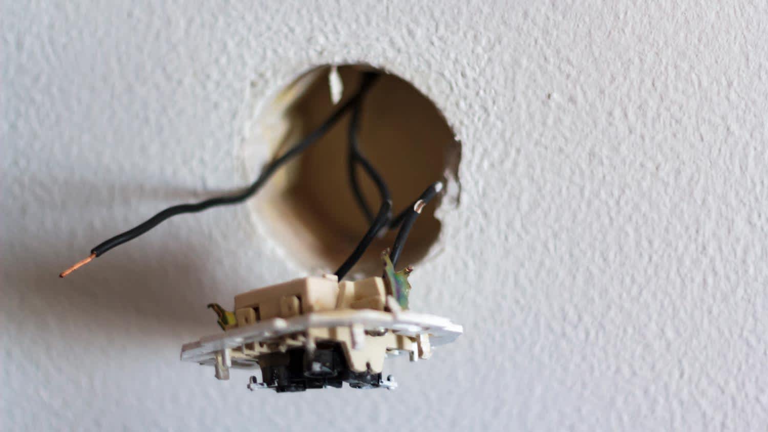 exposed negative hot wires in wall