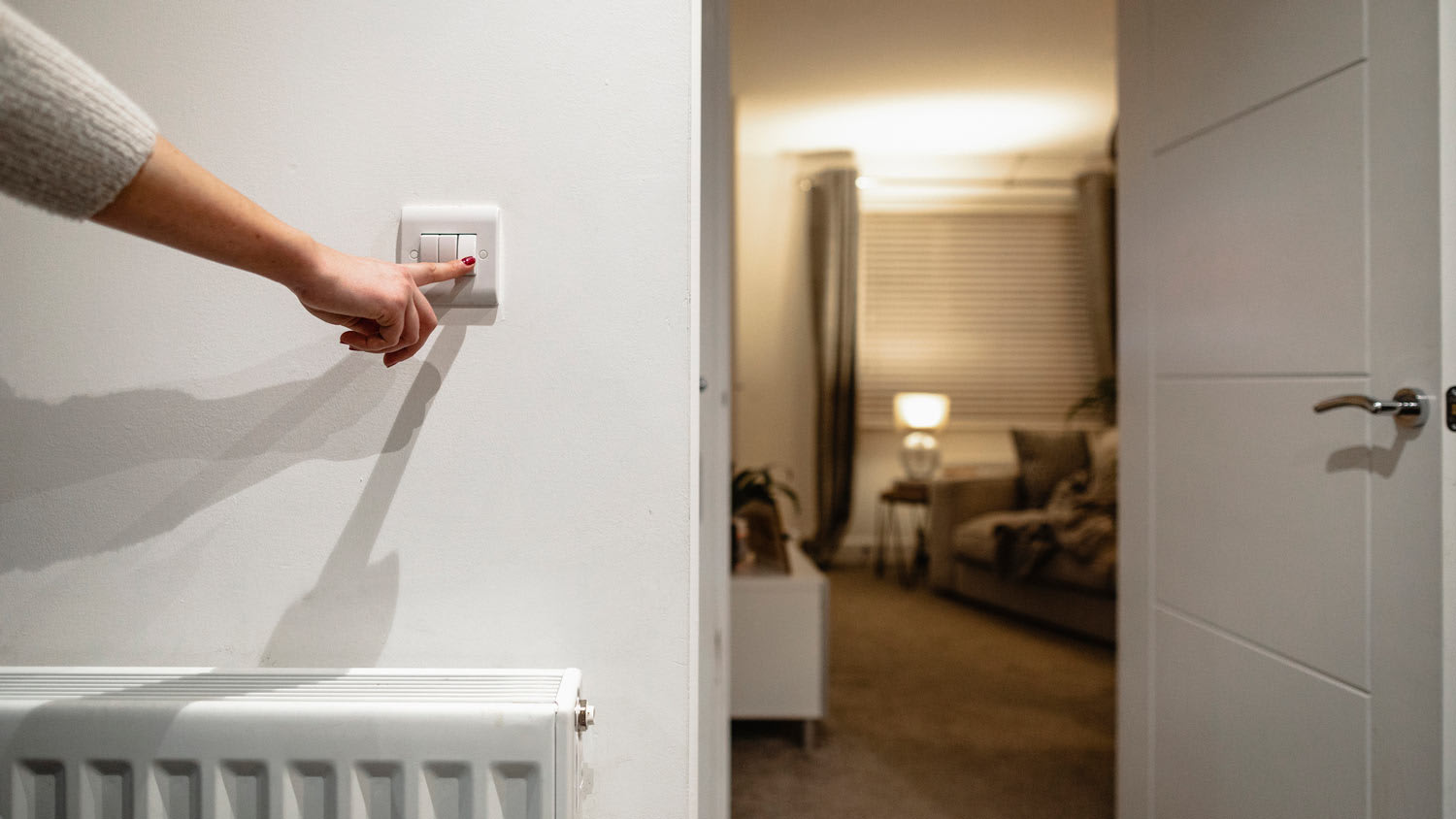 woman turning off lights with switch