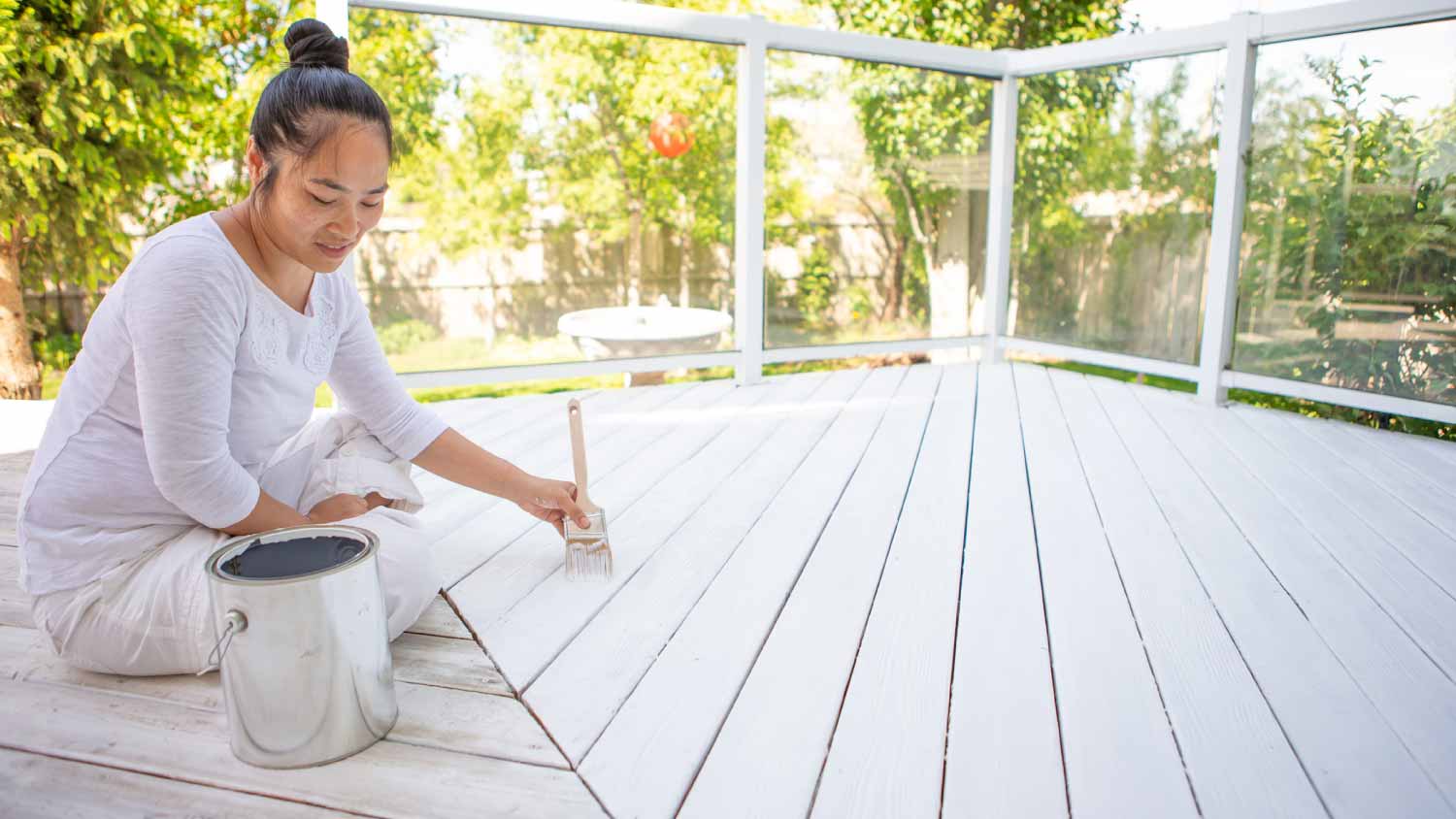 Woman painting deck