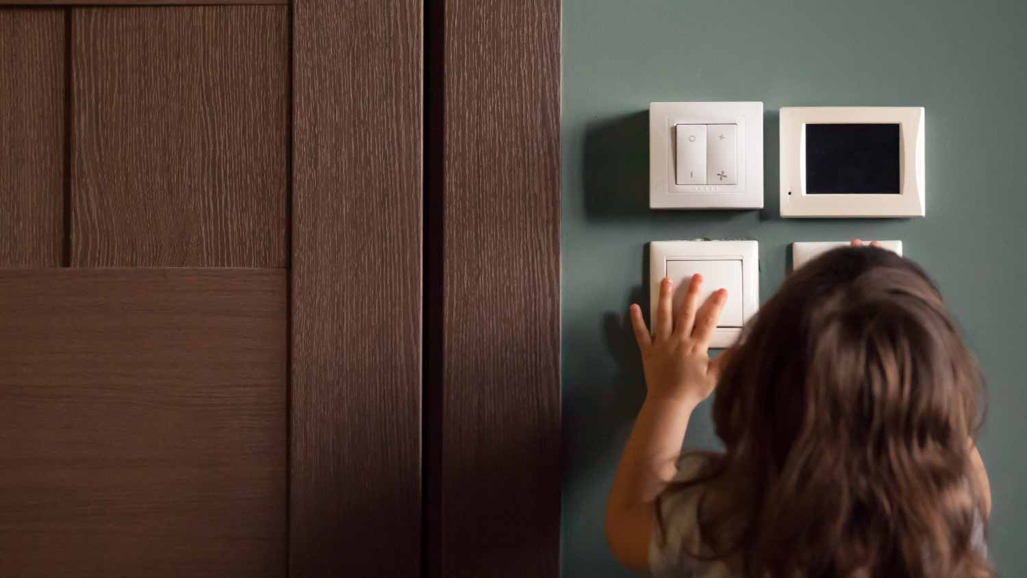 Girl exploring house playing turning light switches