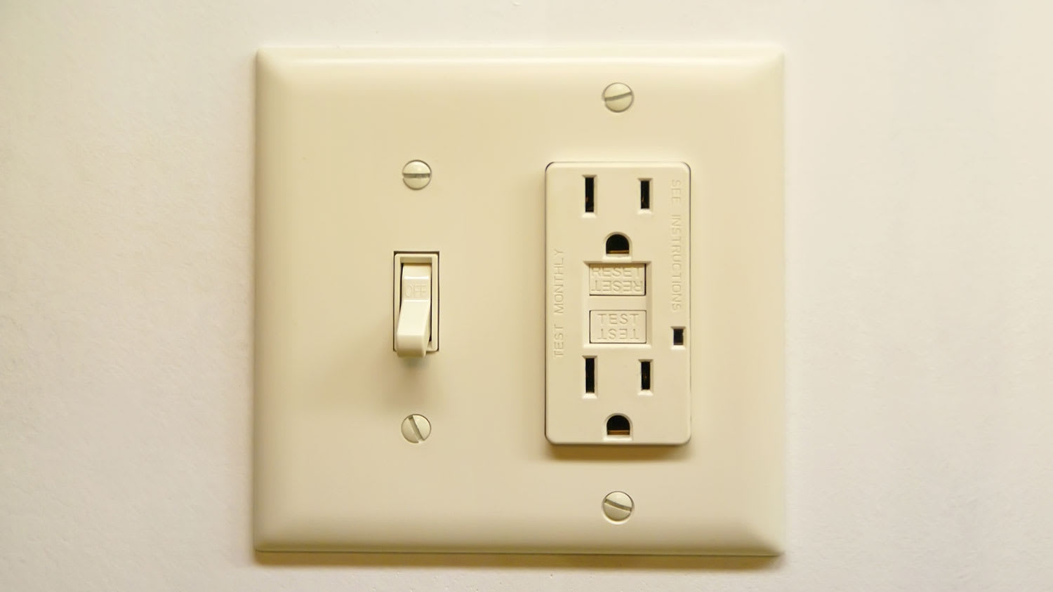 GFCI outlet and light switch mounted on the wall